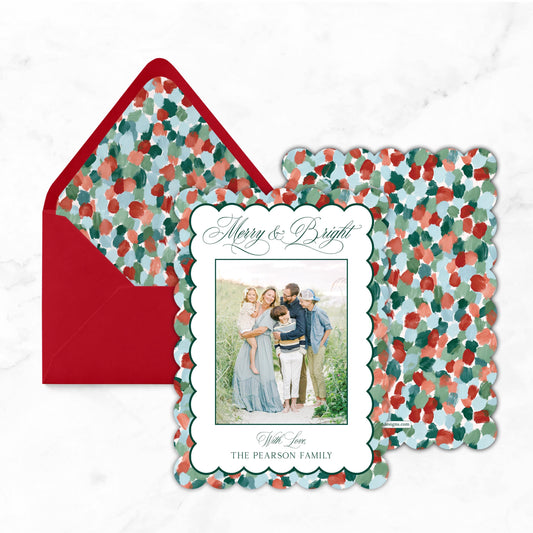 A holiday-themed card with a family photo and a red envelope with a floral pattern.