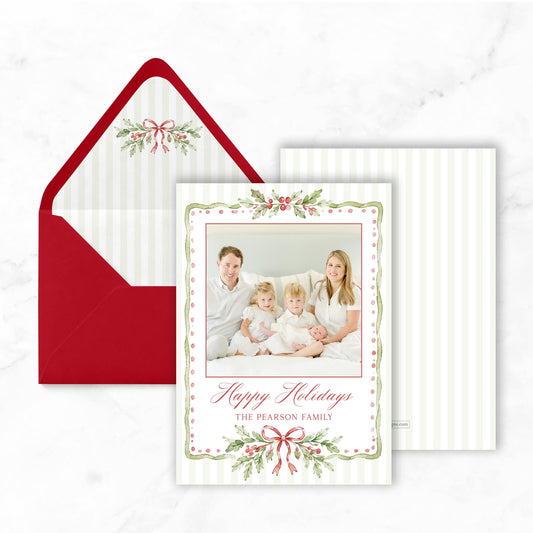 A holiday card featuring a family portrait of a man, woman, and two children, with the text "Happy Holidays The pearson family" displayed on the card.