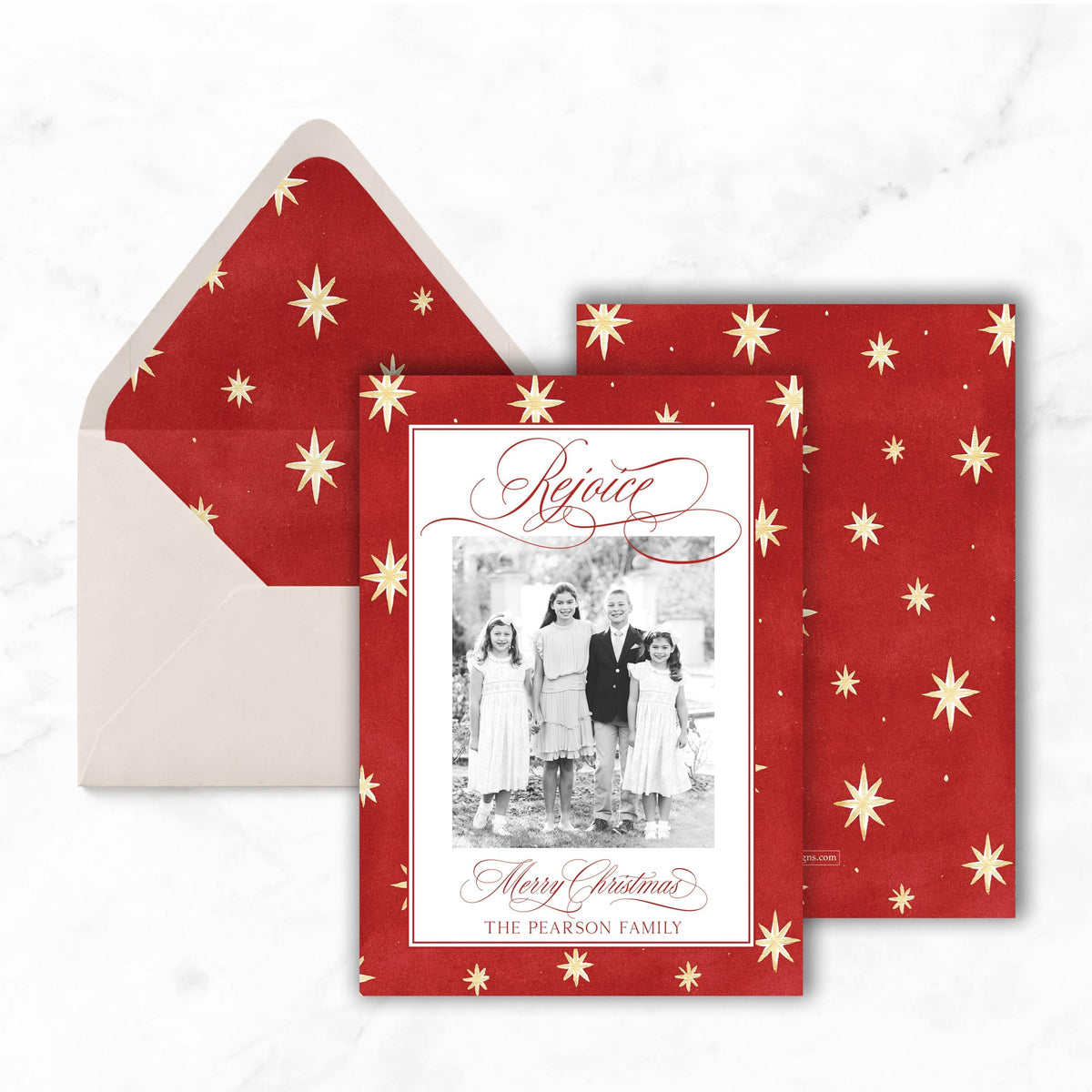 A Christmas card with a family photo and the text "Rejoicing" is displayed, along with an envelope with a red star pattern.