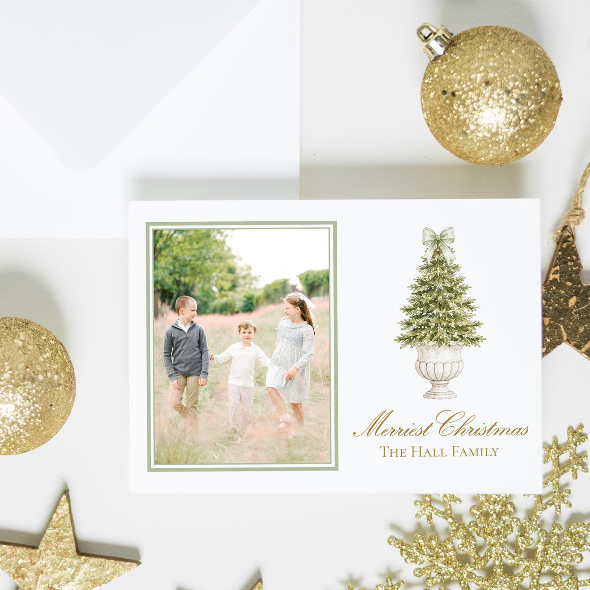 a Christmas card with a family photo, surrounded by various Christmas ornaments and star decorations.
