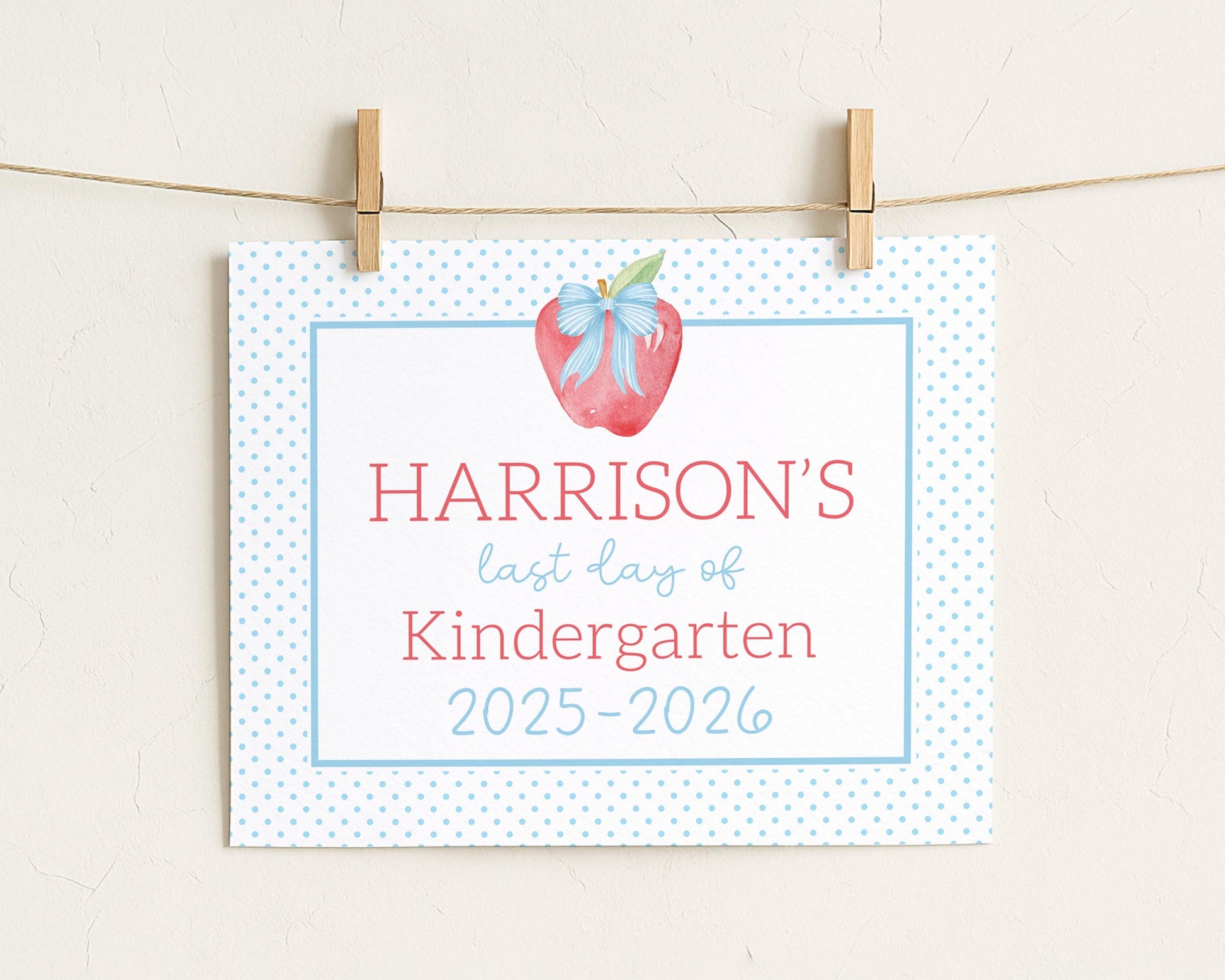 A white sign with blue polka dots hanging on a string.