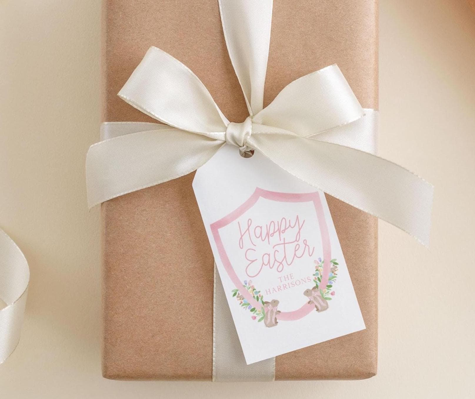 A brown gift box with a white ribbon and a tag that reads "Happy Easter The Harrisons".