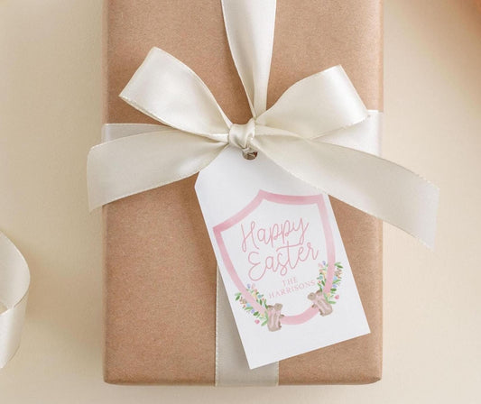 A brown gift box with a white ribbon and a tag that reads "Happy Easter The Harrisons".