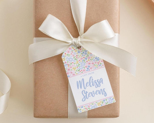 A gift wrapped in brown paper with a white ribbon and a tag that reads "A gift from Melissa Stevens".