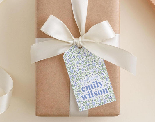 A brown gift box with a white ribbon and a tag that says "A gift from Emily Wilson".