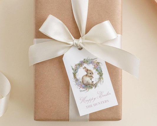 A brown gift box with a white ribbon and a tag featuring a bunny illustration.