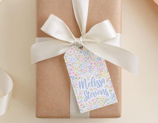 A brown gift box with a white ribbon and a tag that reads "A GIFT FROM Melissa Stevens".
