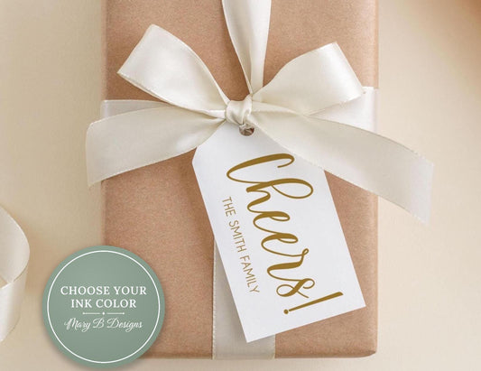 A brown gift box with a white ribbon and a gold tag that says "Cheers! The Smith Family".