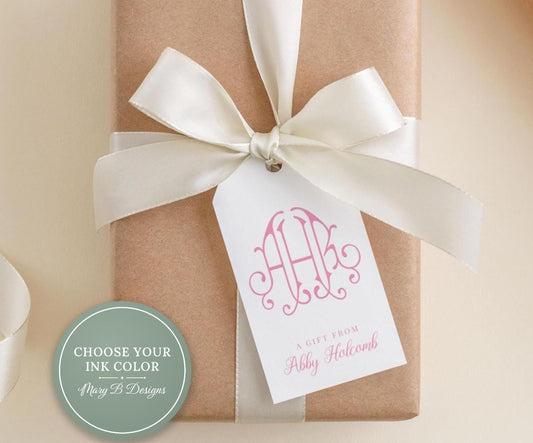 A gift wrapped in brown paper with a white ribbon and a tag that reads "A Gift from Abby Holcomb".
