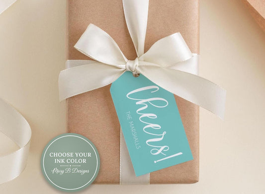 A brown gift box with a white ribbon and a teal tag that says "Cheers! The Marshalls"