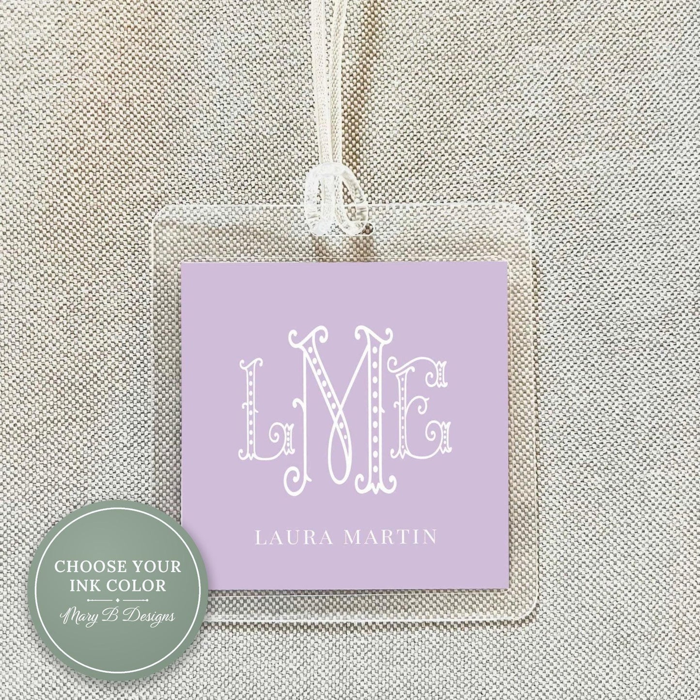 A clear plastic name tag with a purple background and the initials "LME" printed on it.