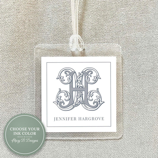 A clear plastic name tag with a monogrammed initial and the name 'Jennifer Hargrove' printed on it.