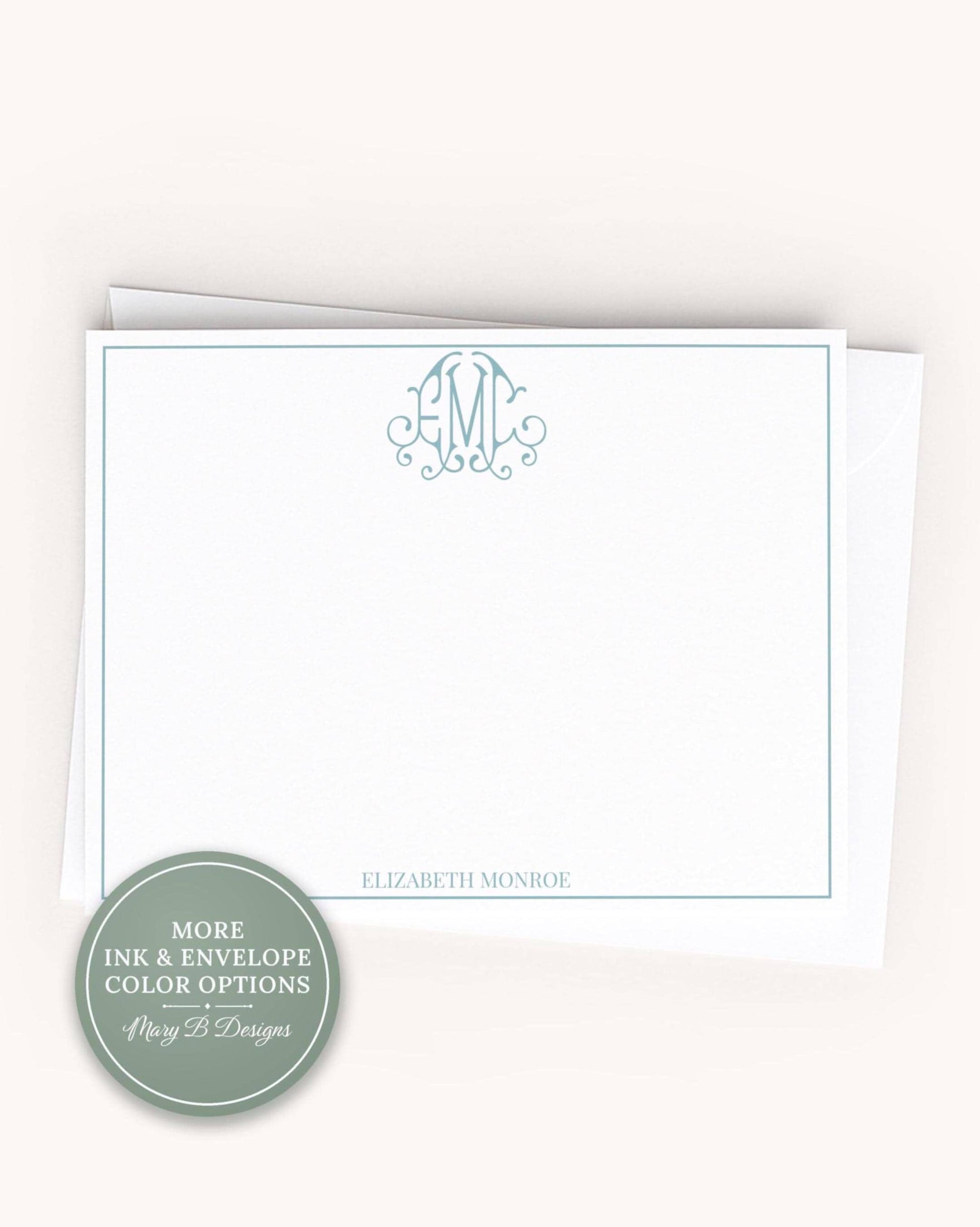 A white card with a teal border and a monogram logo, placed on a plain background.