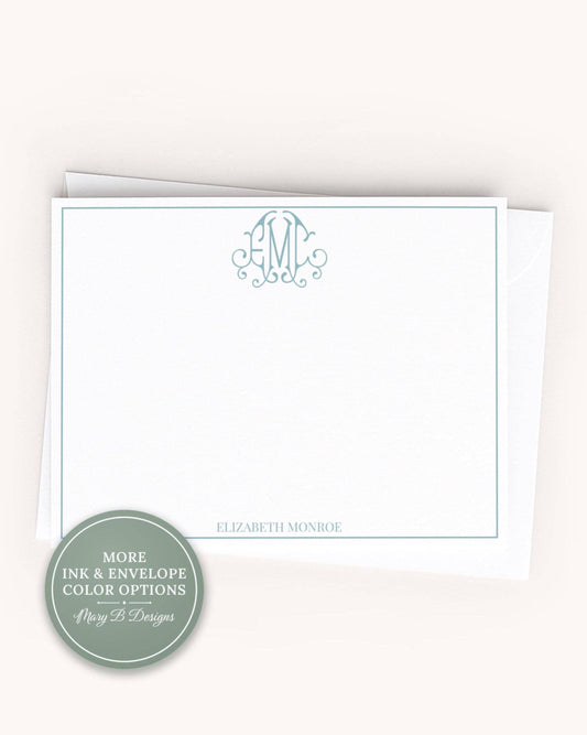 A white card with a teal border and a monogram logo, placed on a plain background.