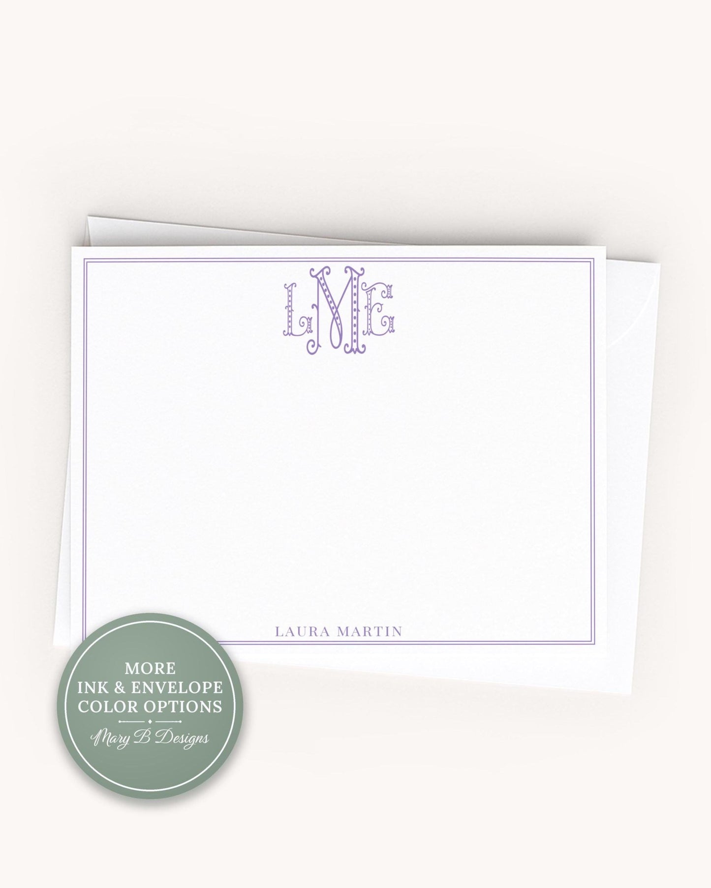 A blank white card with a personalized monogram and the name 'LURA MARTIN' printed on it.