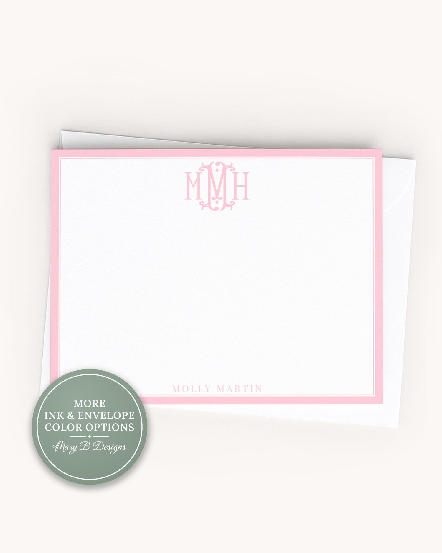 A blank, pink-bordered note card with the initials "M.M.H." printed on it.