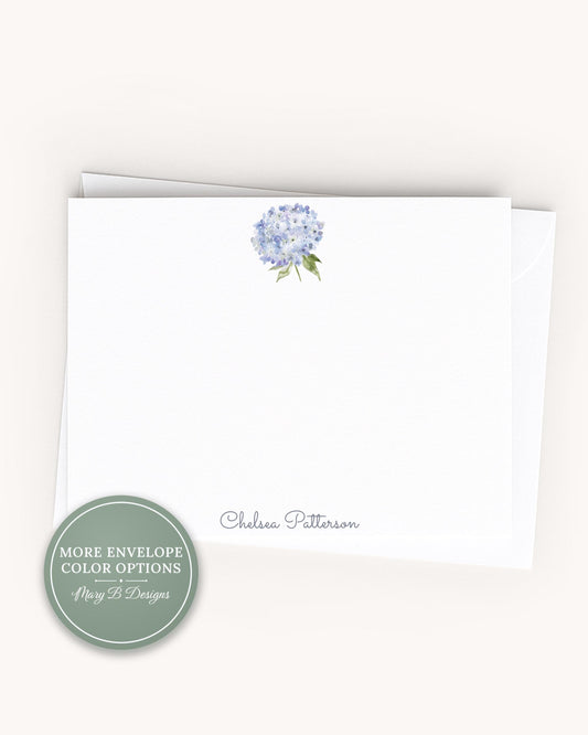 A white card with a blue flower design and the name "Chelsea Pittenson" printed on it.