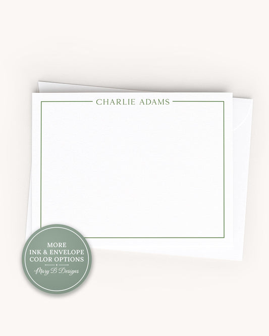 A white card with a green border, featuring the name "Charlie Adams" written in green text.