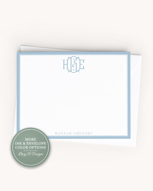 A white card with a blue border, featuring a monogram and the name 'Hannah Gregory' printed on it.