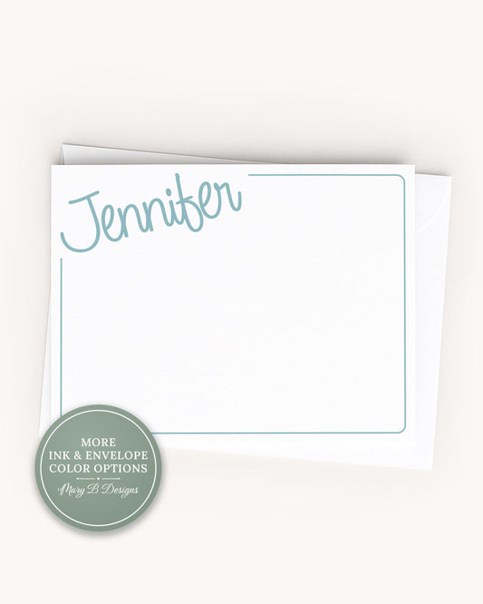 A white card with the name "Jennifer" written on it, placed on top of an envelope.
