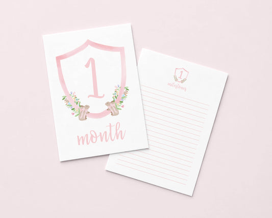 a pink shield-shaped card with the number "1" and the text "month" on it, along with a lined paper pad below it.