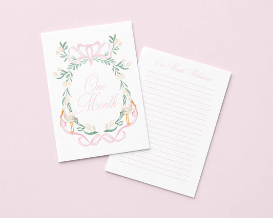 a white card with a floral design and the text "One Month" written on it, along with a lined paper pad.