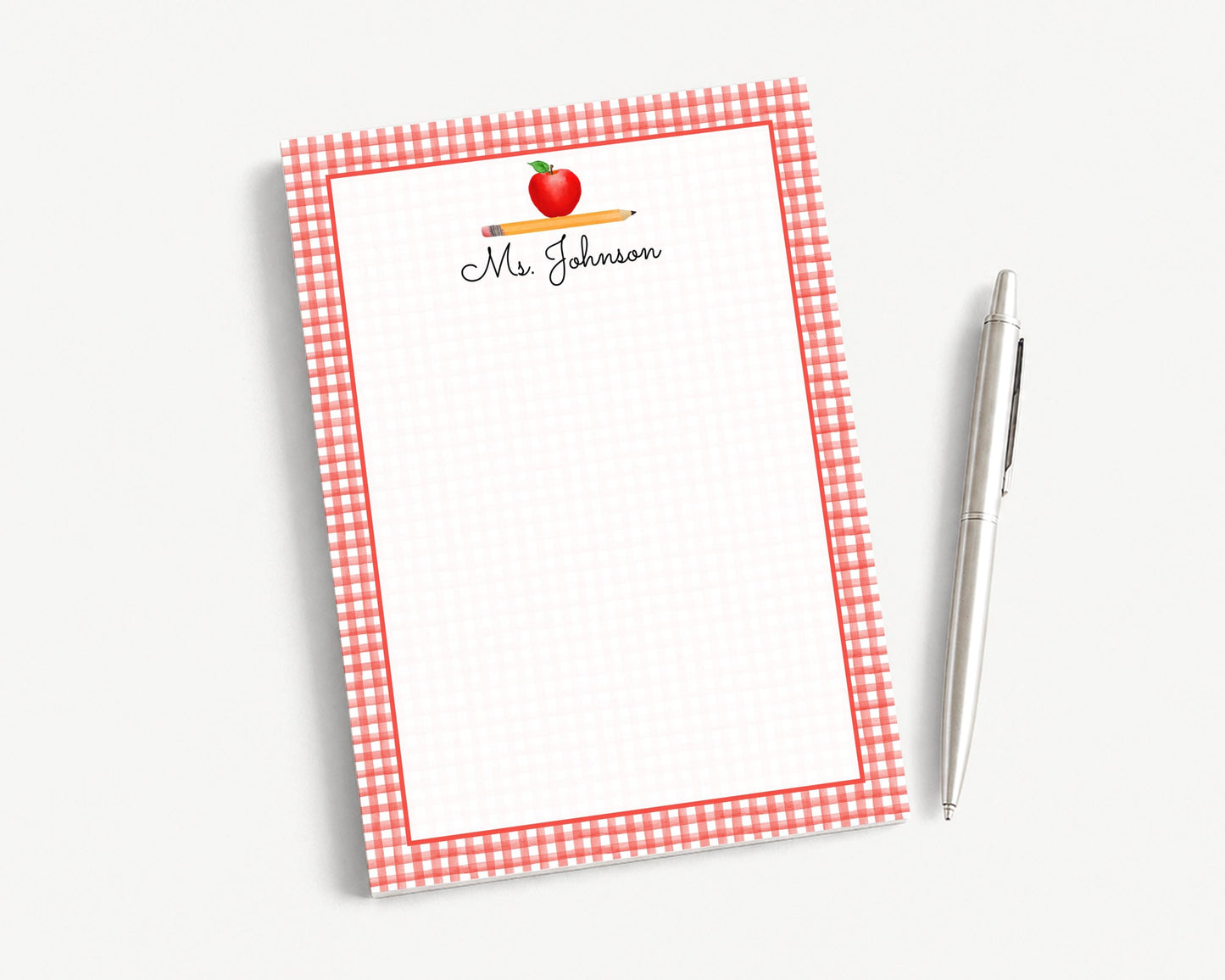 A red and white checkered notepad with a pencil and a pen on a white background.