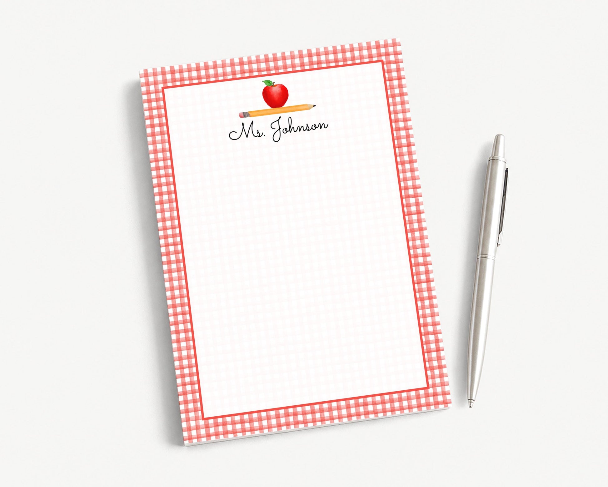 A red and white checkered notepad with a pencil and a pen on a white background.