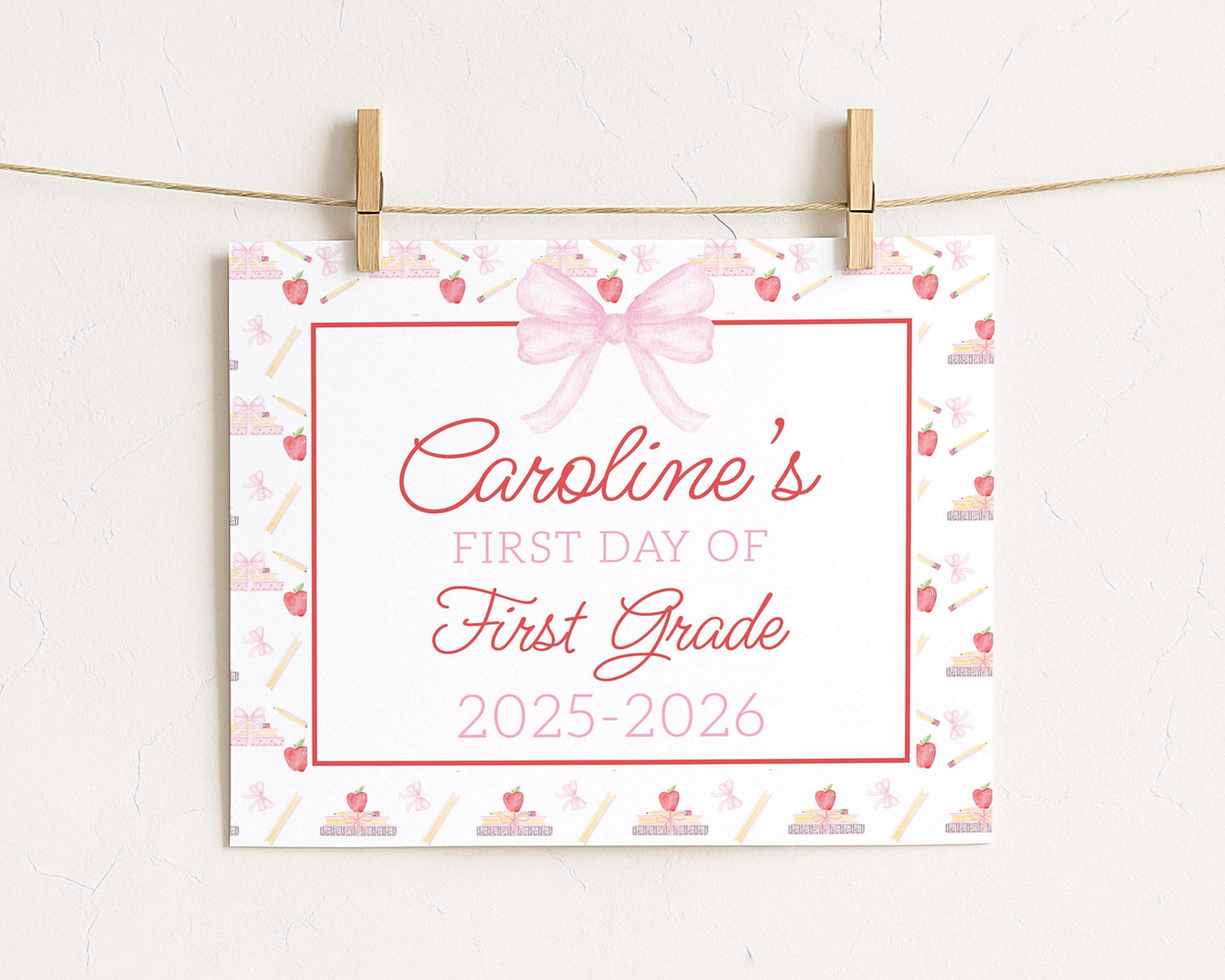 A white sign with a pink bow and the text "Caroline's FIRST DAY OF FIRST GRADE" is hanging on a string.