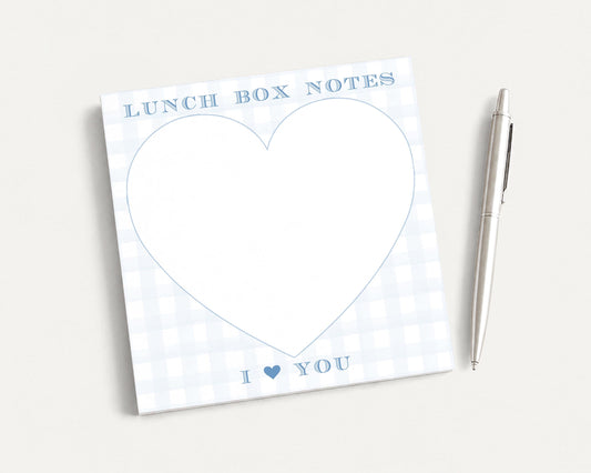 a heart-shaped blank pad with the text "I ❤ YOU" written on it, accompanied by a pen on a plain white background.