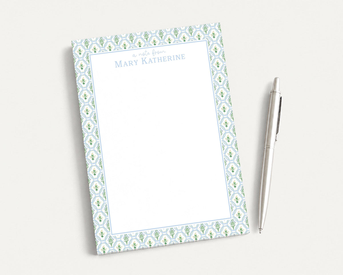 A blank notepad with a floral pattern and a pen are placed on a white surface. __etsy:8206501700