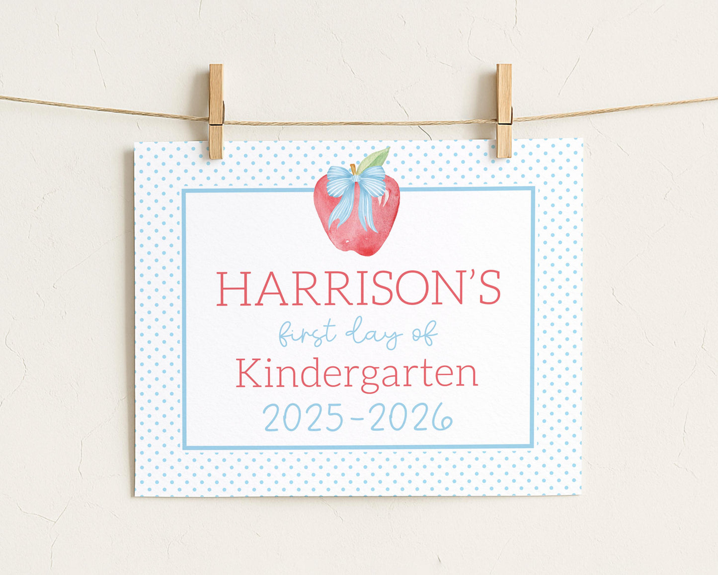 A white sign with blue polka dots hanging on a string.