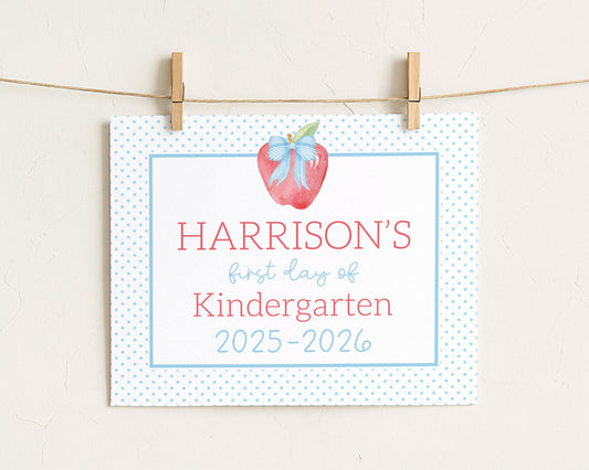 A white sign with blue polka dots hanging on a string.
