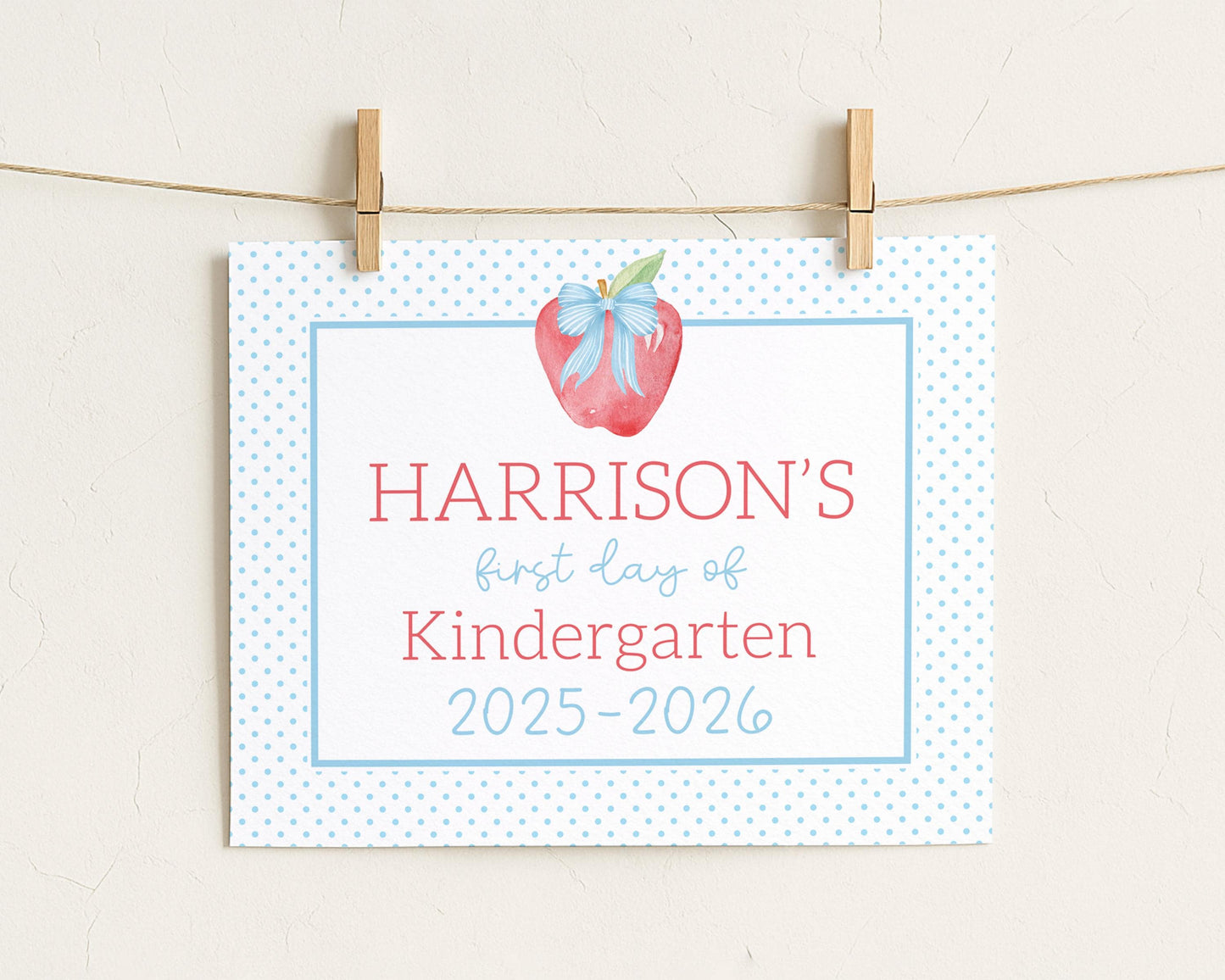 A white sign with blue polka dots hanging on a string.