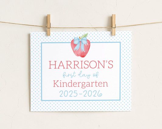 A white sign with blue polka dots hanging on a string.