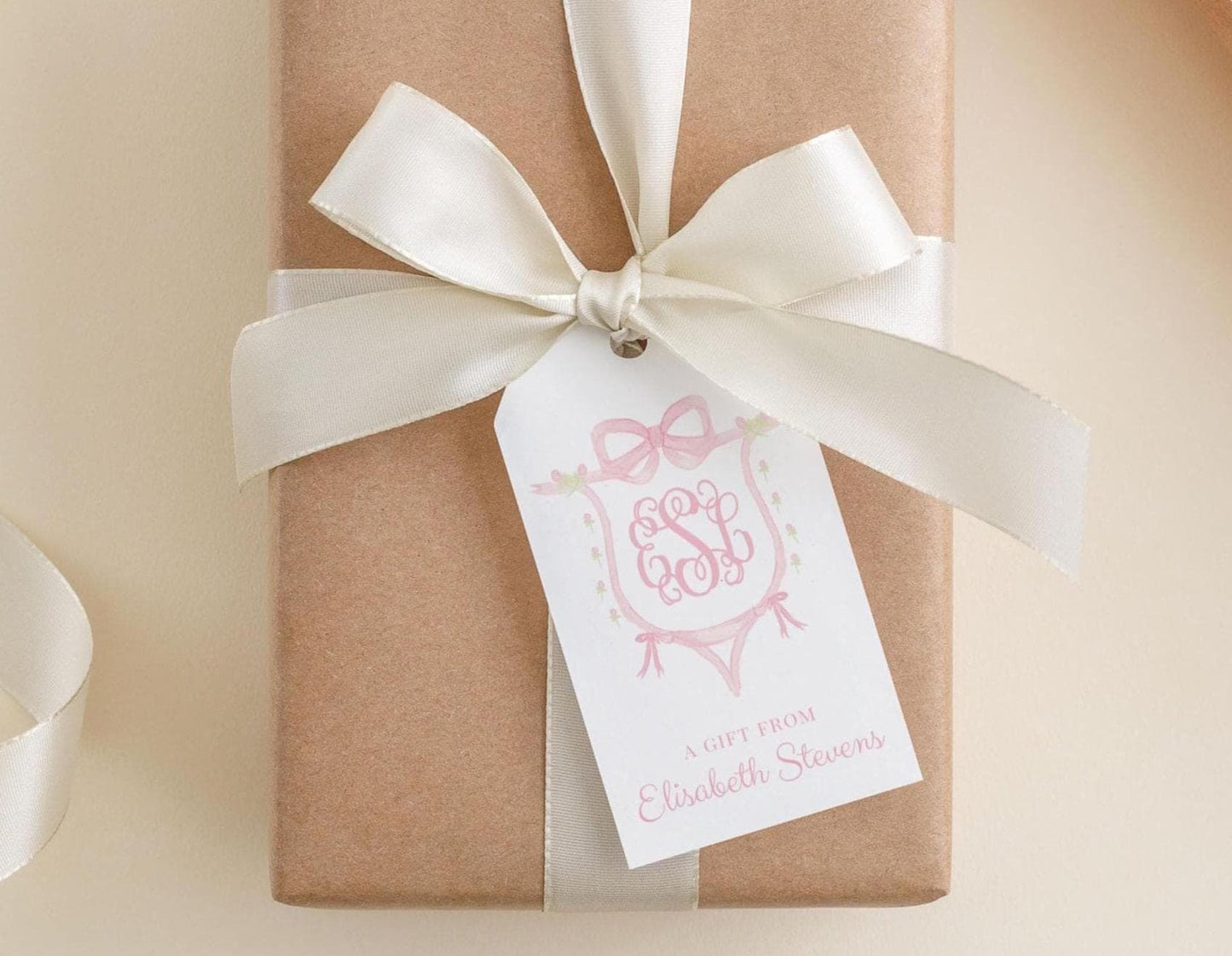 A brown gift box with a white ribbon and a tag that reads "A gift from Elizabeth Stevens".