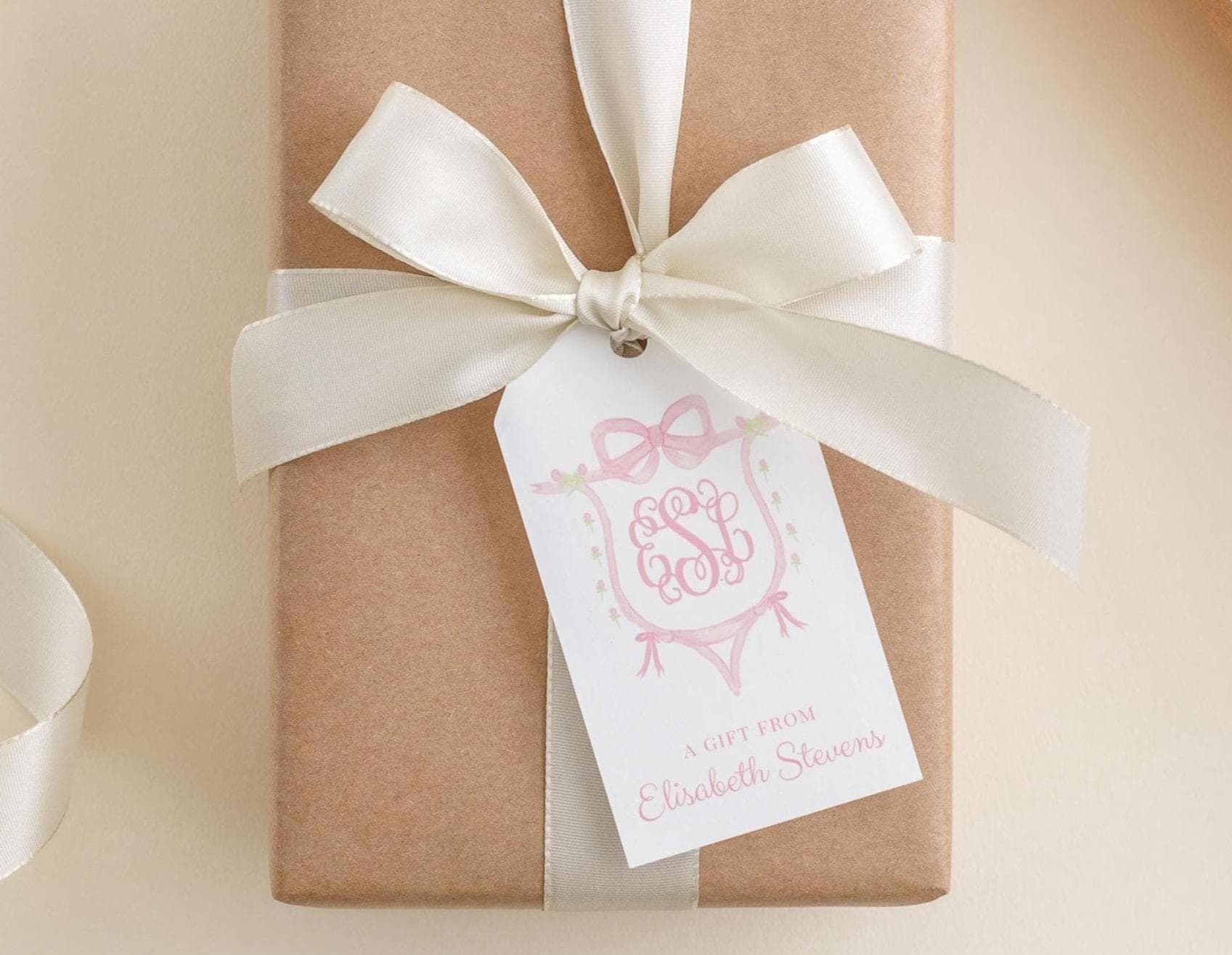 A brown gift box with a white ribbon and a tag that reads "A gift from Elizabeth Stevens".
