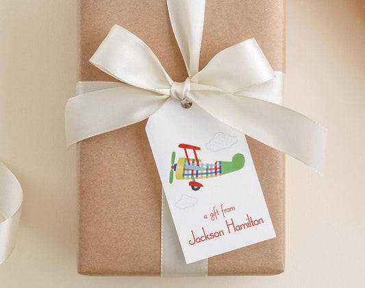 A brown gift box with a white ribbon and a tag that reads "a gift from Jackson Hamilton".