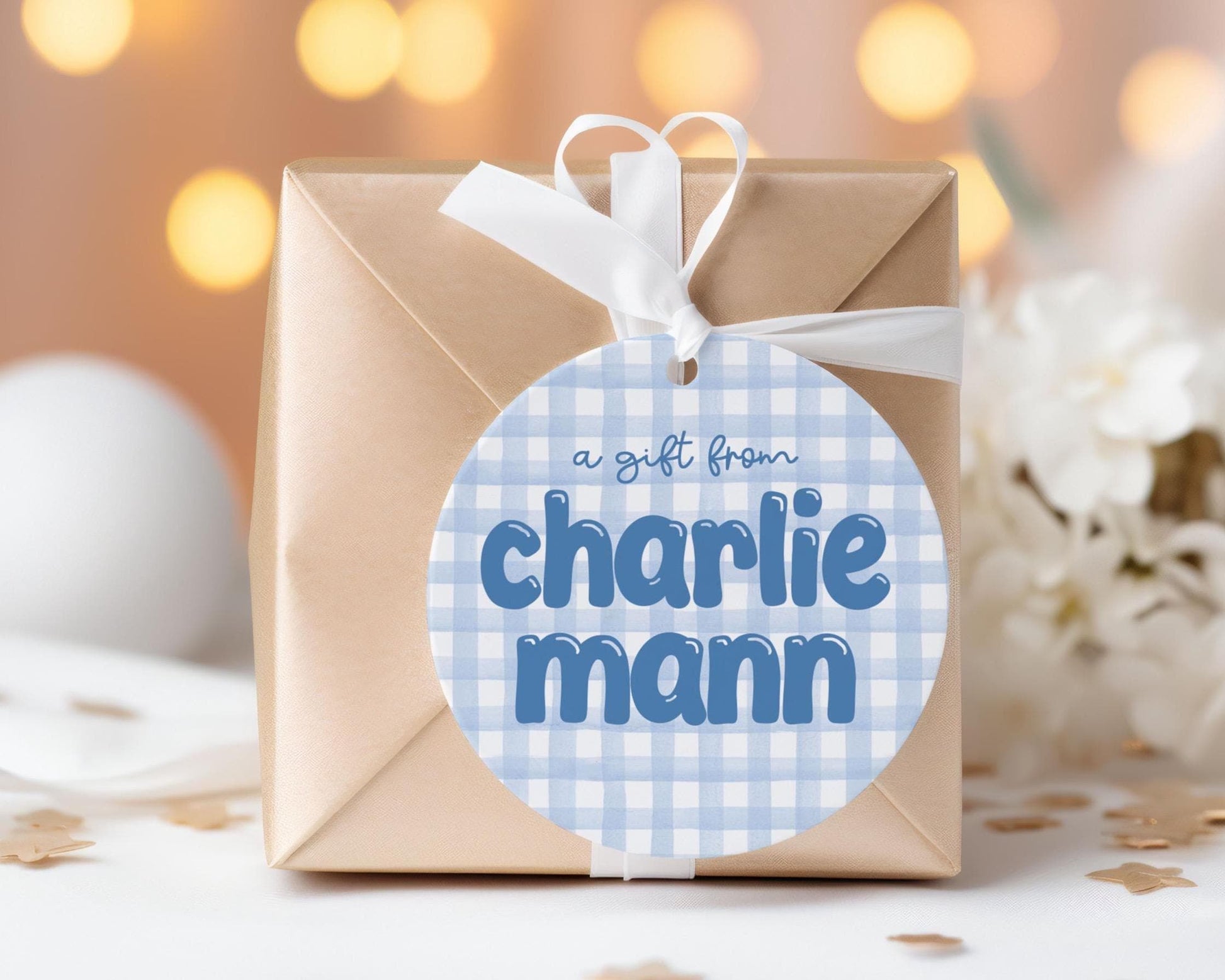 A gift wrapped in brown paper with a blue and white checkered label that says "a gift from Charlie Mann".
