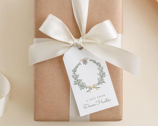 A gift wrapped in brown paper with a white ribbon and a white tag that reads "A gift from Diane Hunter".