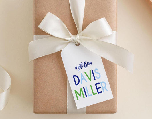 A gift wrapped in brown paper with a white ribbon and a tag that reads "a gift from DAVIS MILLER".