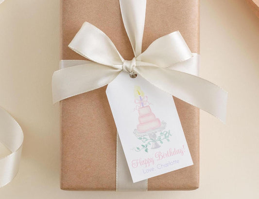 A brown gift box with a white ribbon and a tag that reads "Happy Birthday! Love, Charlotte".