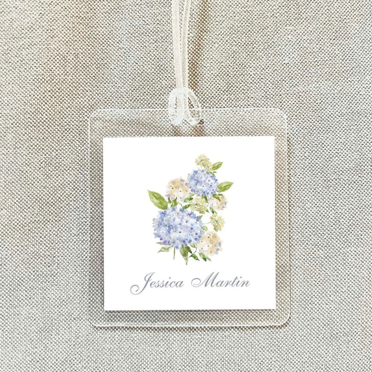 A clear plastic name tag with a floral design and the name " Jessica Martin" printed on it.