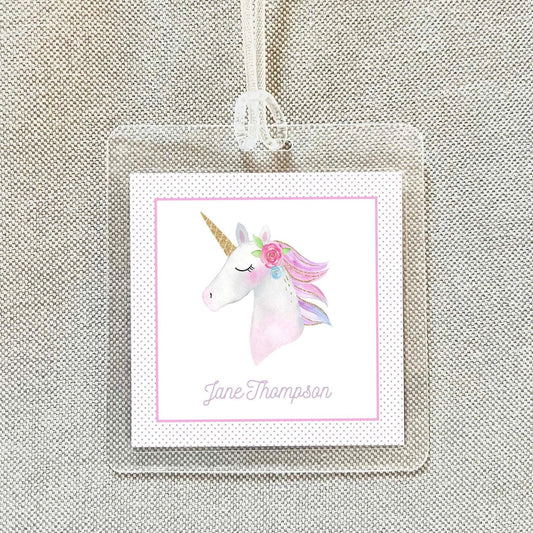 A clear name tag with a pink and white unicorn illustration and the name "Jane Thompson" printed on it.