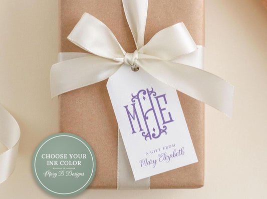 A gift wrapped in brown paper with a white ribbon and a purple tag that reads "A gift from Mary Elizabeth".