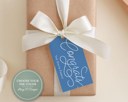 A brown gift box with a white ribbon and a blue tag that reads "Congratulations The Davis Family".
