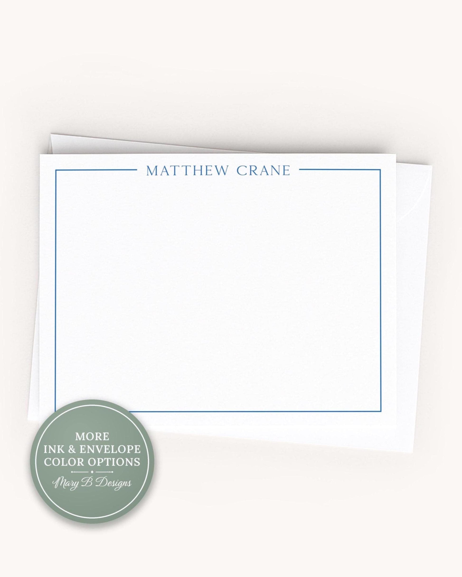 A blank white card with the name 'MATTHEW CRANE' printed on it, placed on top of an envelope.