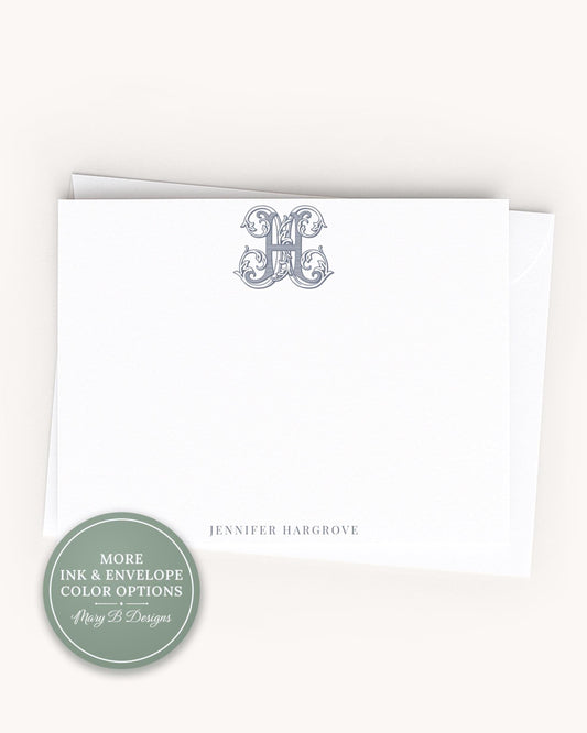 A white card with a monogrammed initial and the name 'JENNY HARRGOVE' printed on it.