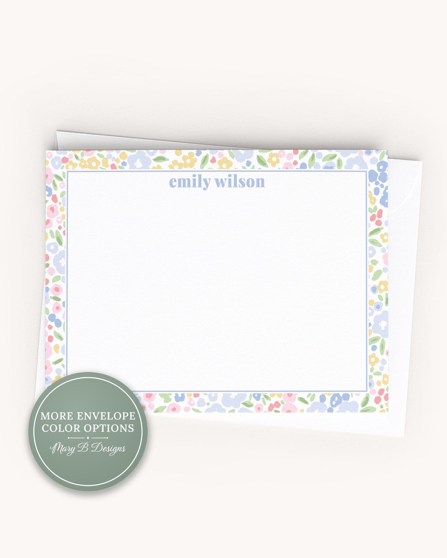 A blank card with a floral border, placed on a plain surface.