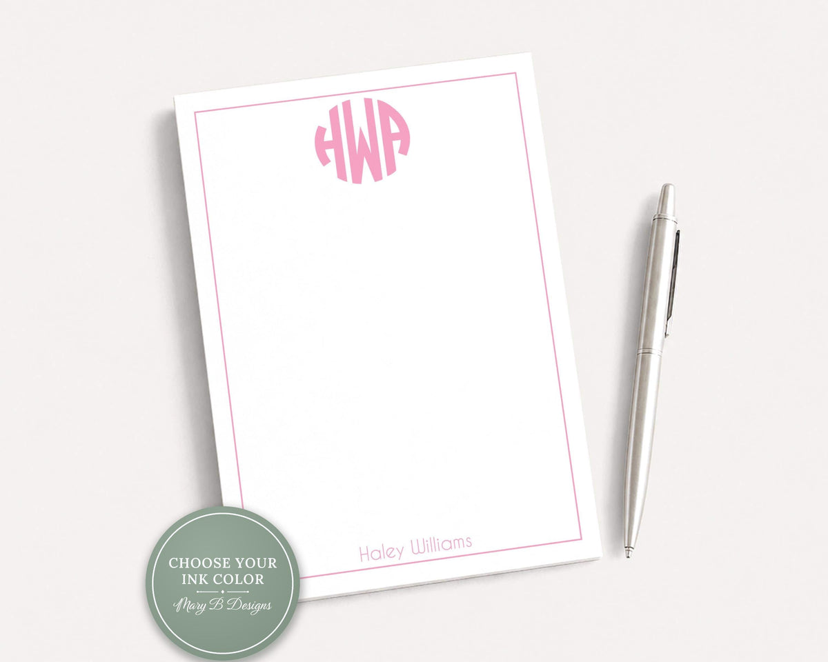 a white notepad with a pink border and a pen, both placed on a white surface. __etsy:8254374157